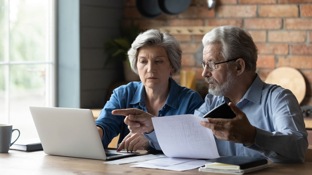Senior couple sitting together looking over finances