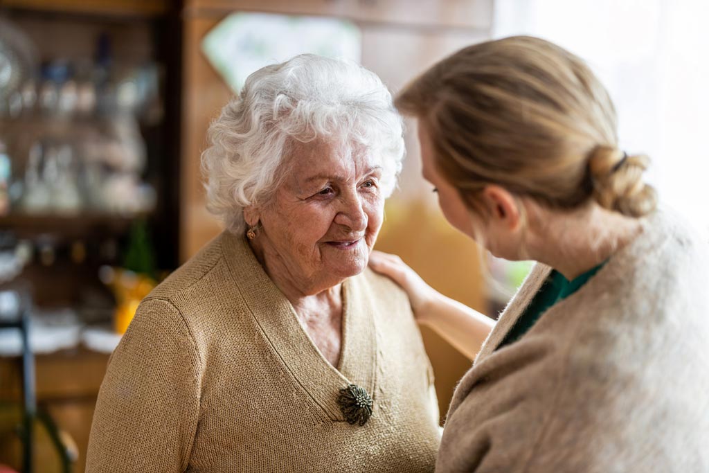 Health worker speaking with elderly dementia patient