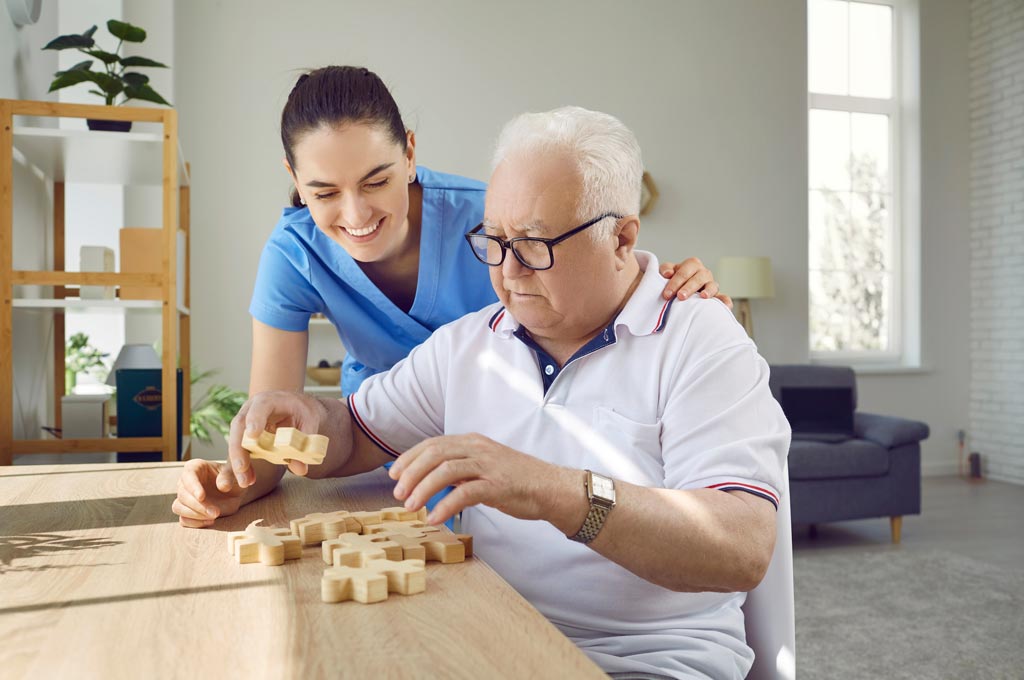 Nurse in assisted living helping patient with dementia