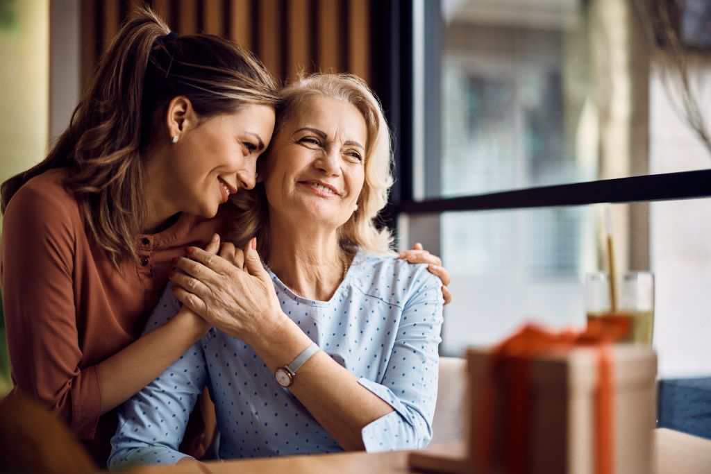 Happy senior woman enjoying in daughter's affection