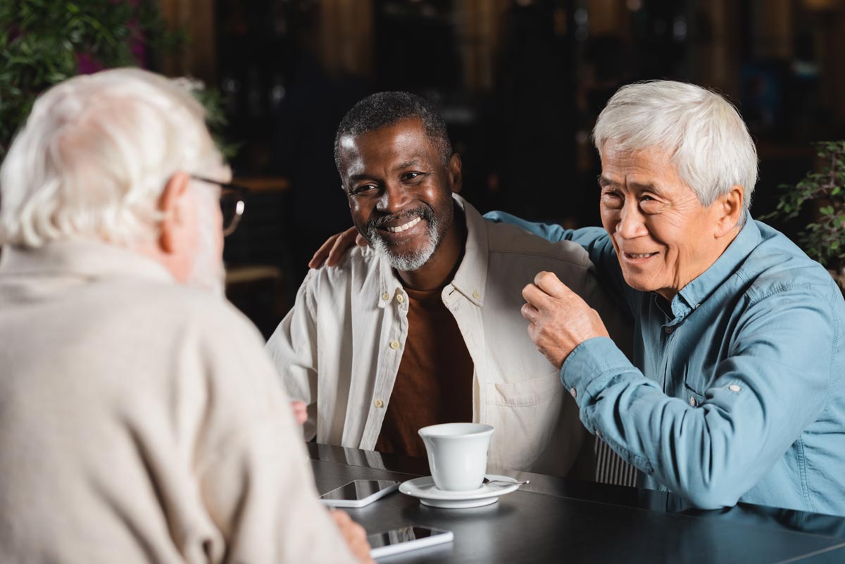 Seniors at an assisted living community sitting around a table enjoying social interaction