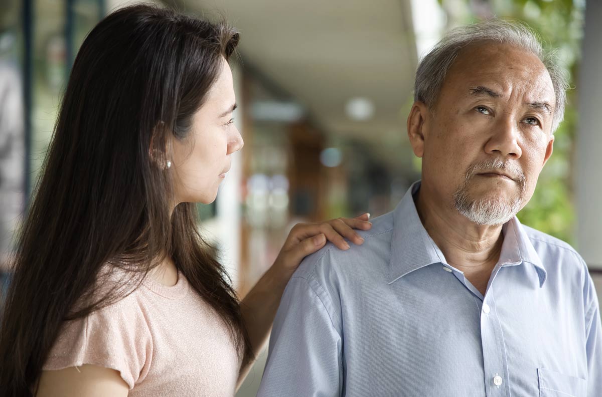 Middle aged woman daughter taking care of her senior father suffering from Alzheimer's disease