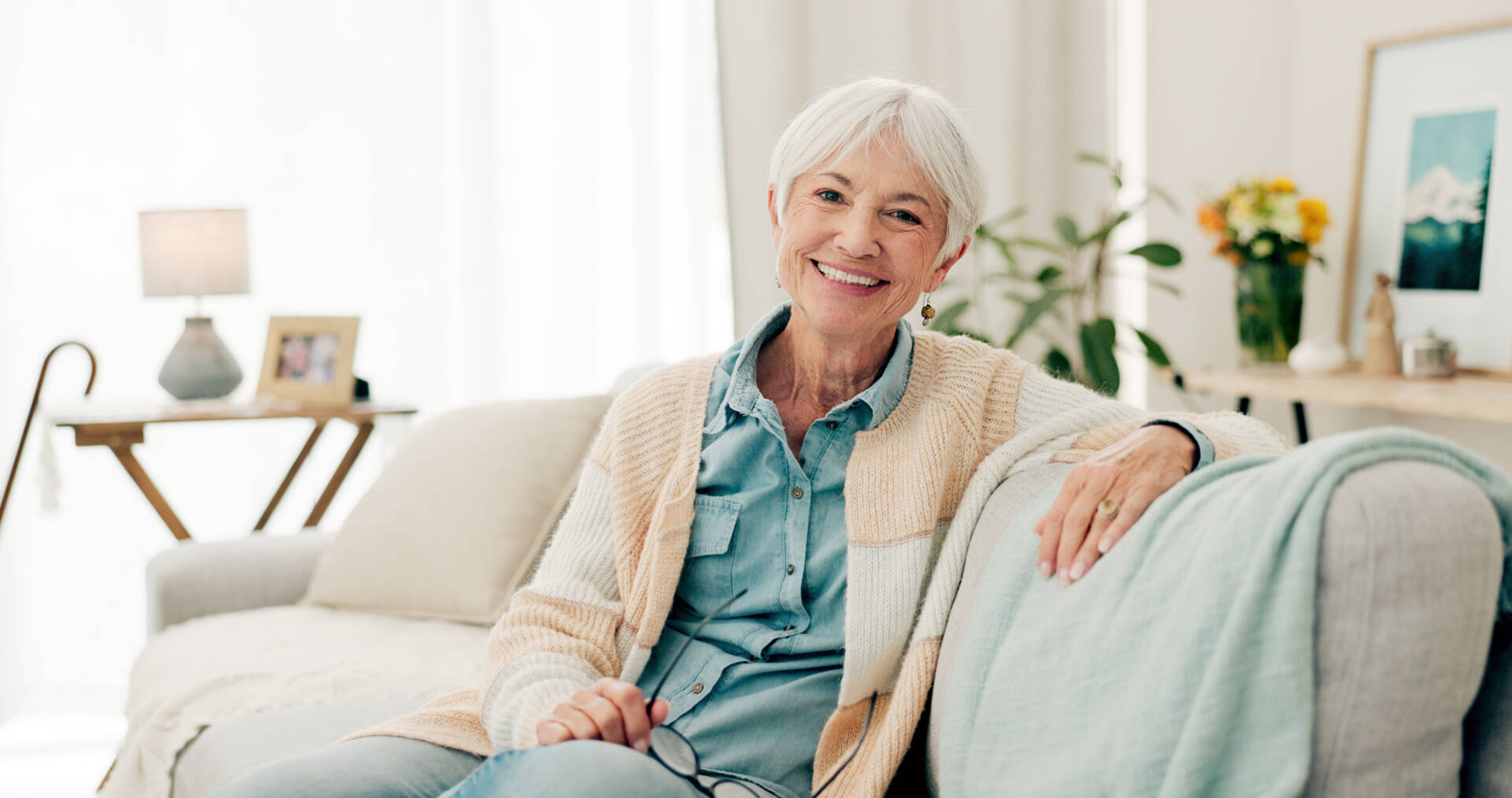 Senior Woman And Relax On Sofa In Nursing Home